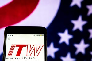 A smartphone showing the Illinois Tool Works logo in front of an American flag