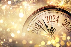 A clock ticking past “2023” and toward “2024”