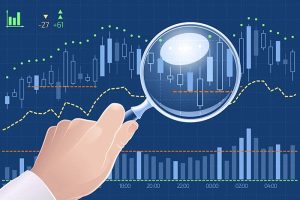 A candlestick stock chart under a magnifying glass