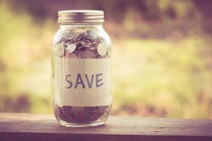 A jar of coins with a “SAVE” label on the side