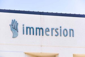 The logo of Immersion Corporation on the side of a building