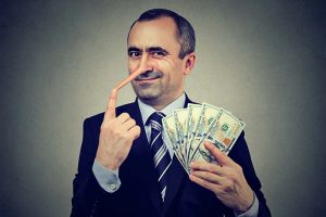 A businessman with a growing nose holding a stack of cash