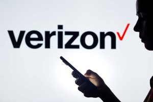 The Verizon logo behind an outline of a person holding a cell phone