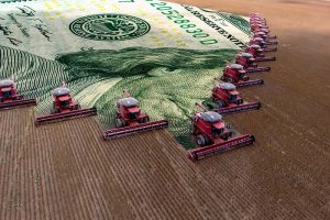 A row of combines harvesting a field, with an image of a U.S. dollar bill behind them