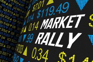 The words “market rally” surrounded by various stock tickers and prices