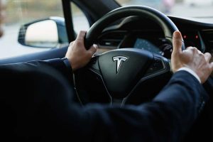 A steering wheel with the Tesla logo