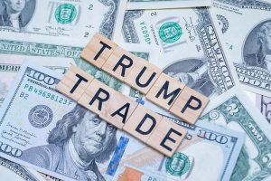 Blocks spelling out “Trump trade” sitting on several U.S. dollar bills