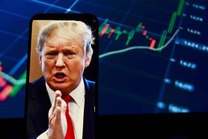 A photo of President Trump on a smartphone in front of a rising stock chart