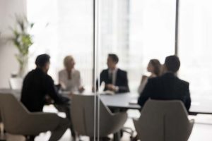Several company executives sitting around a table in a conference room