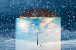 A sunny sky under an umbrella, surrounded by a dark, rainy sky outside the umbrella