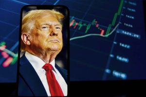 An image of President Trump on a smartphone in front of a rising stock chart
