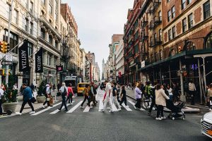 People crossing a busy street in New York City