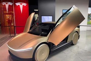 A Tesla robotaxi (or Cybercab) on display in a showroom