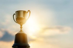 A trophy with the sun shining in the background