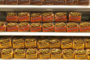 Several rows of Nature’s Own bread on the shelf in a grocery store