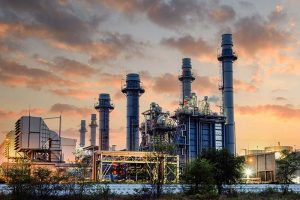 A natural gas combined cycle power plant photographed at sunset