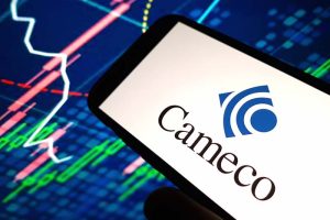 The Cameco logo on a smartphone, with a stock chart in the background