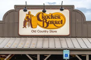 The Cracker Barrel logo on the front of a restaurant