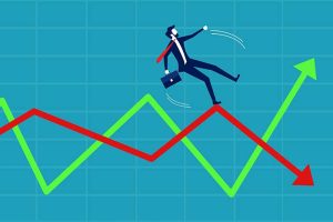 A graphic of a well-dressed man carrying a briefcase, slipping on volatile red and green arrows