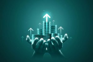 A pair of hands holding stacks of coins with upward arrows above them