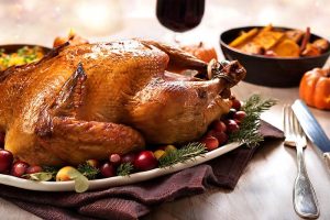 A turkey sitting on a Thanksgiving table