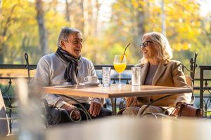 A retirement-age couple sitting at a table smiling