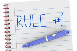 “Rule #1” written on a notepad in all capital letters in blue ink