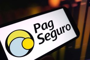 The logo for PagSeguro on a smartphone