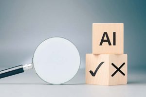 A wooden block with “AI” written on it stacked on top of another block with an “X” and a check mark on it