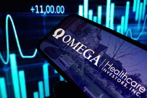 The Omega Healthcare Investors logo on a smartphone