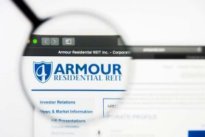 A magnifying glass giving a close-up view of the Armour Residential REIT logo on the company’s website