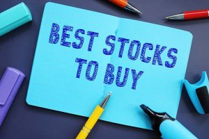 “Best stocks to buy” written in a blue notebook