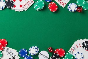 Poker chips, cards, and dice on a green poker table