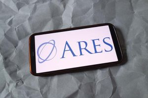 The Ares Capital logo on a smartphone against a gray background