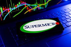 The Supermicro logo on a smartphone lying on a keyboard